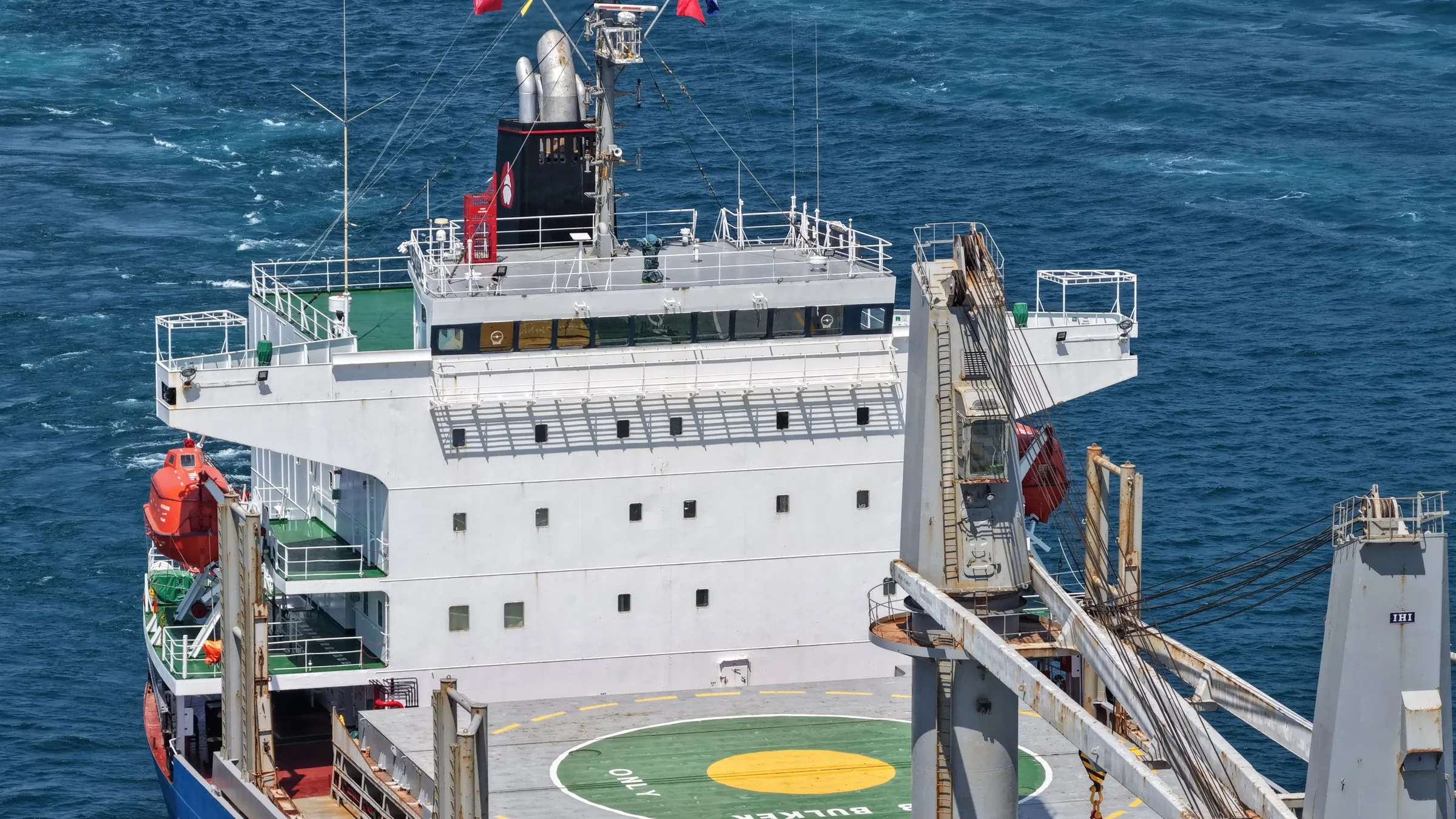 Altair bulk carrier accommodation and cranes at sea.